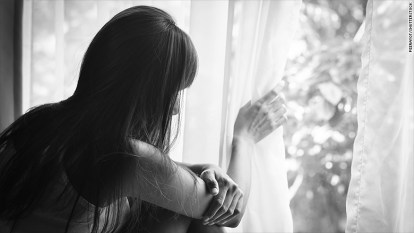 Woman looking out window